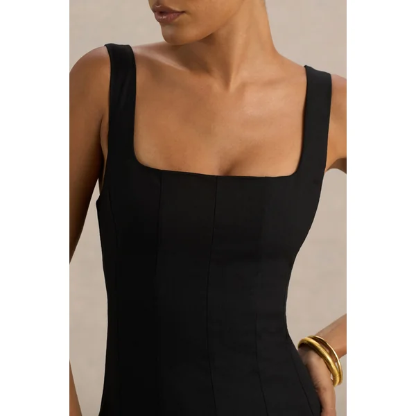 Magnolia | Robe mi-longue noire à décolleté arrondi taille basse et détails à volants