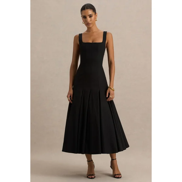 Magnolia | Robe mi-longue noire à décolleté arrondi taille basse et détails à volants