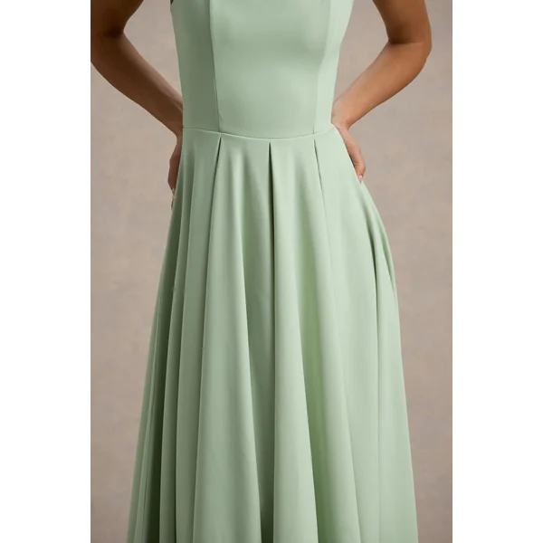 Parina | Robe mi-longue vert clair à bretelles et ourlet volumineux