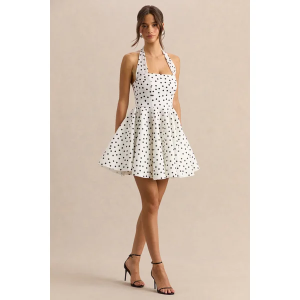 Peggy | Mini-robe patineuse à pois noirs et blancs à encolure dos-nu