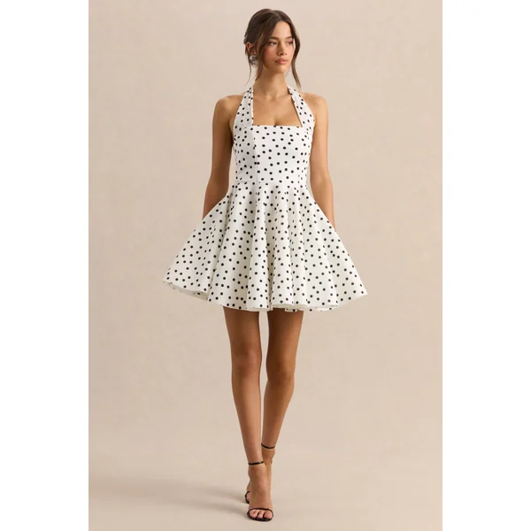 Peggy | Mini-robe patineuse à pois noirs et blancs à encolure dos-nu