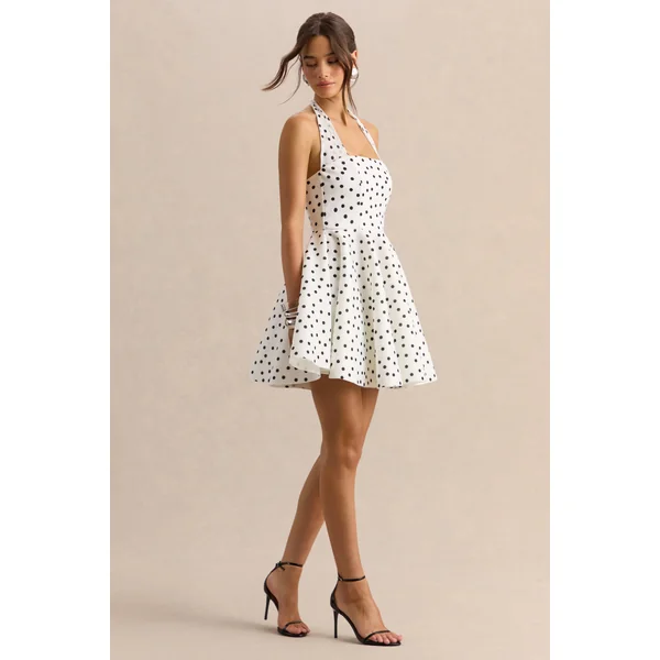 Peggy | Mini-robe patineuse à pois noirs et blancs à encolure dos-nu