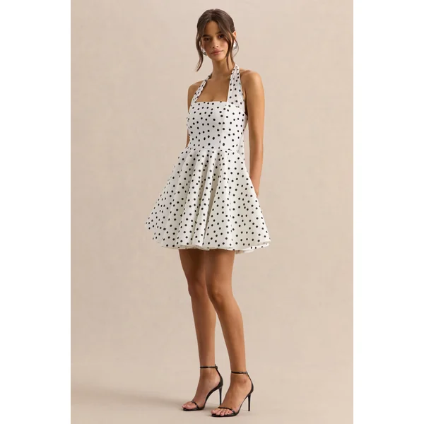 Peggy | Mini-robe patineuse à pois noirs et blancs à encolure dos-nu