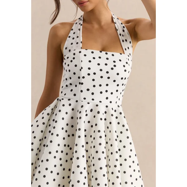 Peggy | Mini-robe patineuse à pois noirs et blancs à encolure dos-nu